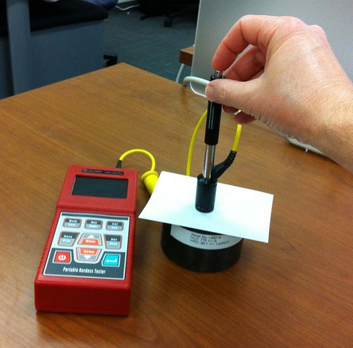 Image of a portable, rebound-indent tester being used on a polymer backsheet.